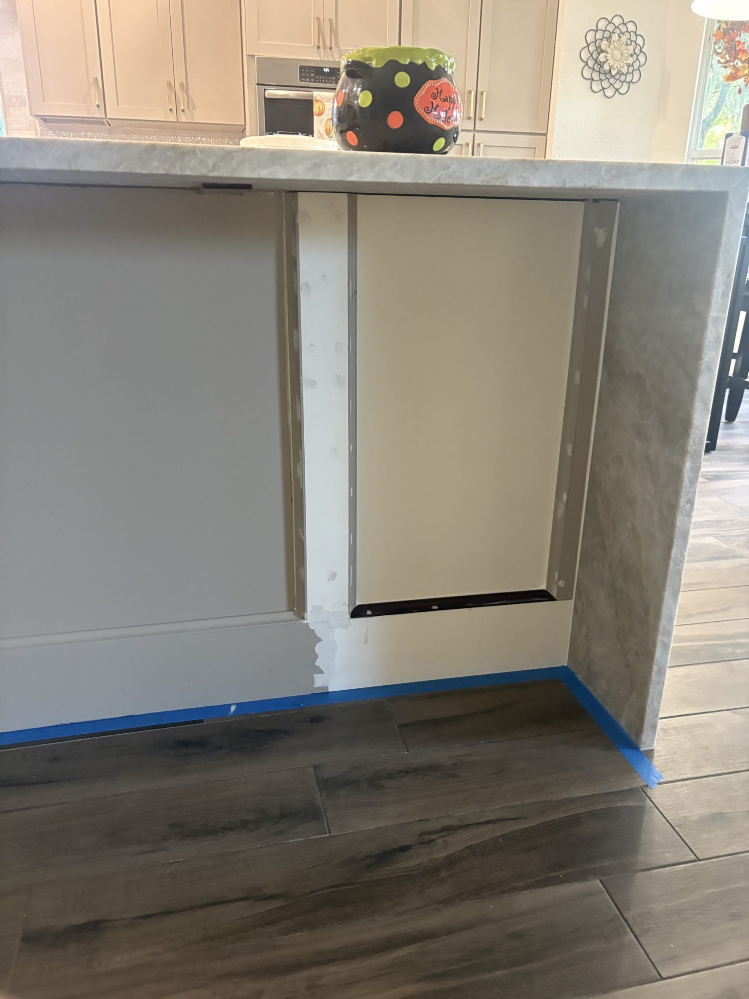 Island back paneling extended to wrap the new cabinet