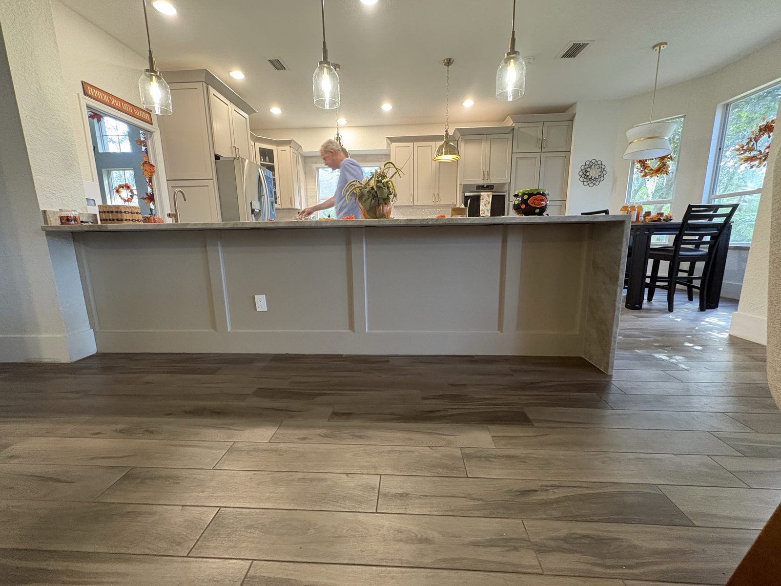 Finished paneled island back with waterfall countertop ends